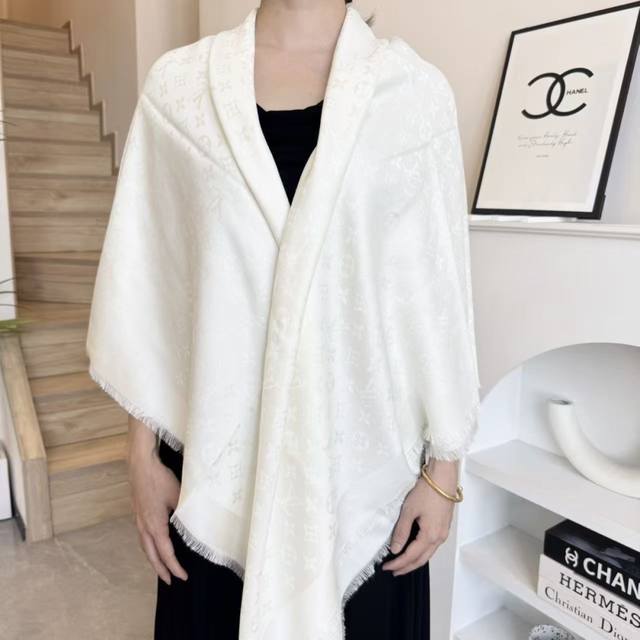 This Louis Vuitton square scarf/shawl features classic gold thread paired with a