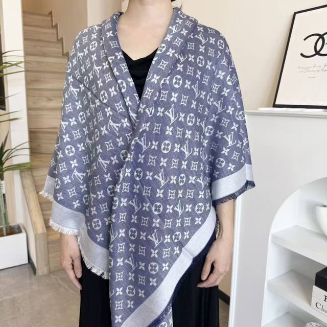 This Louis Vuitton square scarf/shawl features classic gold thread paired with a