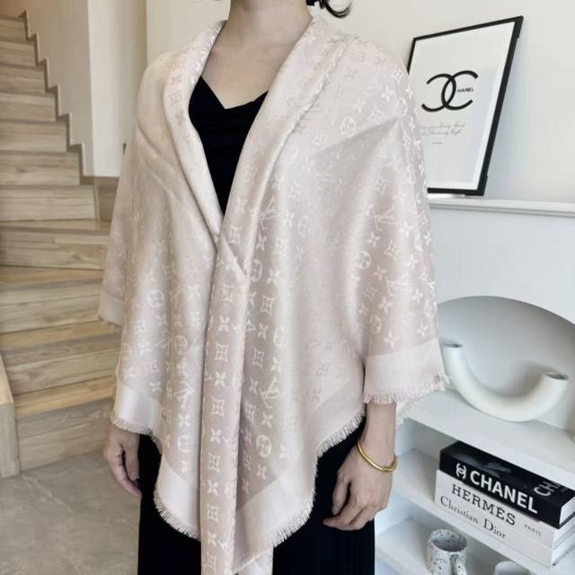 This Louis Vuitton square scarf/shawl features classic gold thread paired with a