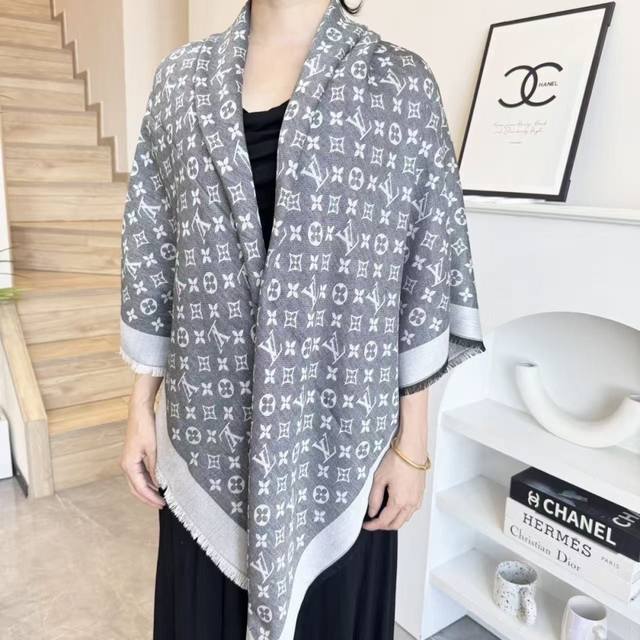 This Louis Vuitton square scarf/shawl features classic gold thread paired with a