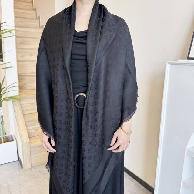 This Louis Vuitton square scarf/shawl features classic gold thread paired with a