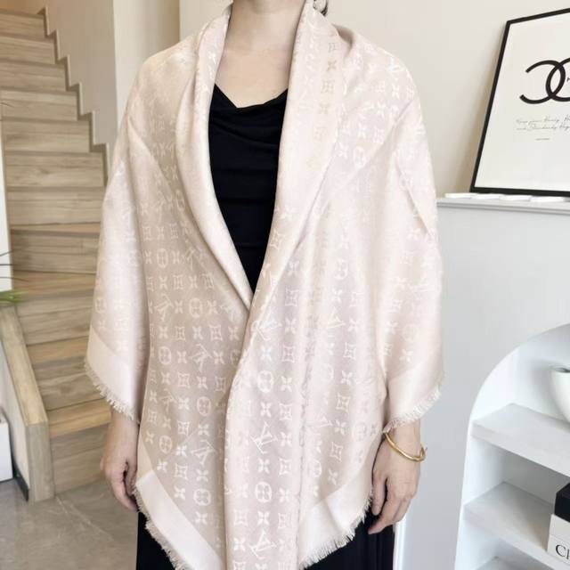 This Louis Vuitton square scarf/shawl features classic gold thread paired with a