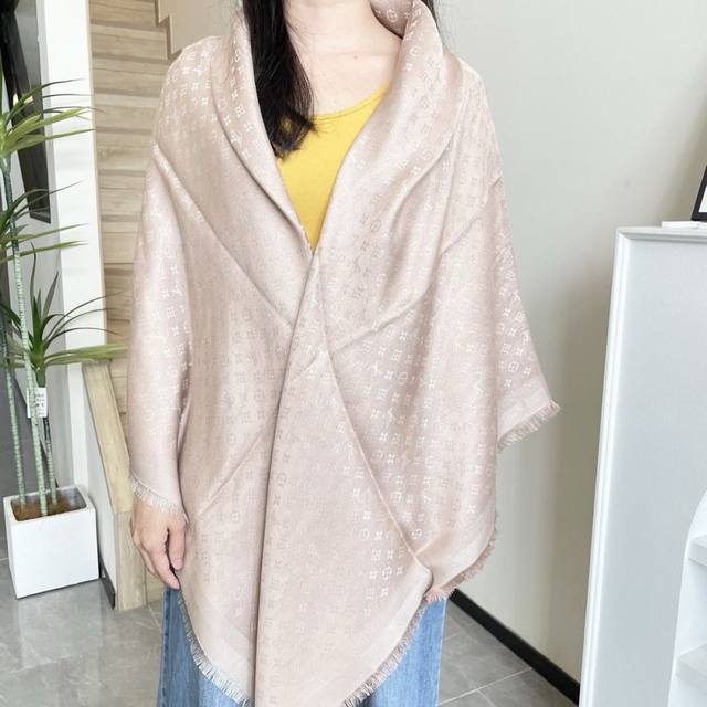 This Louis Vuitton square scarf/shawl features classic gold thread paired with a