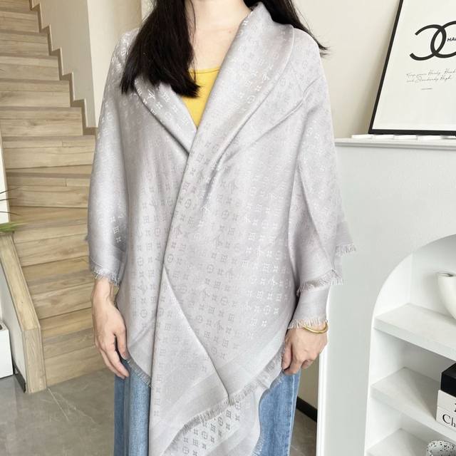 This Louis Vuitton square scarf/shawl features classic gold thread paired with a