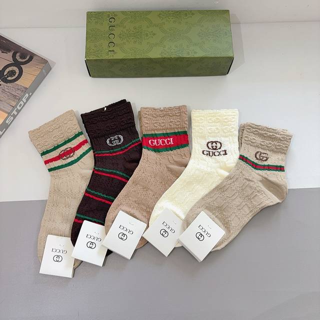 A box of 5 pairs of Gucci's new early autumn mid-calf socks, complete with packa