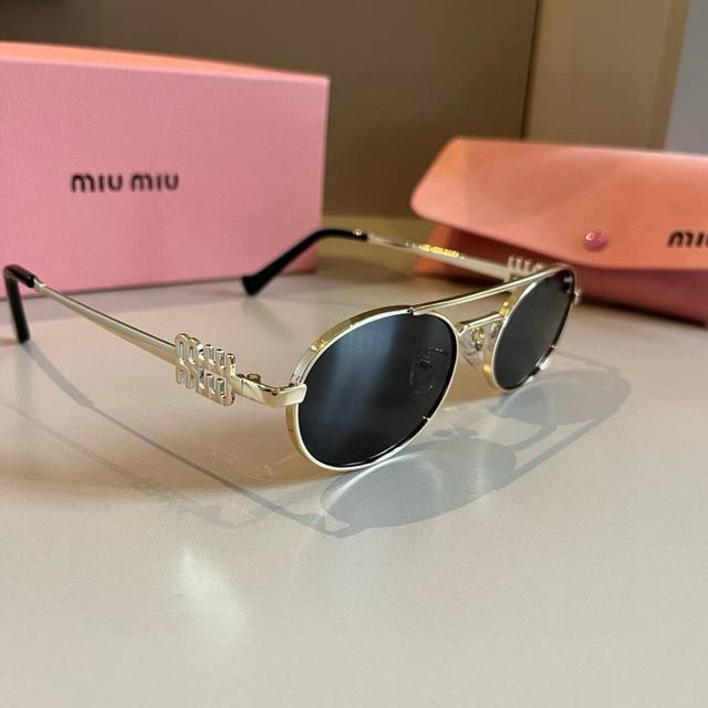 A super cool and exquisite pair of Miumiu metal-framed sunglasses. Wearing them