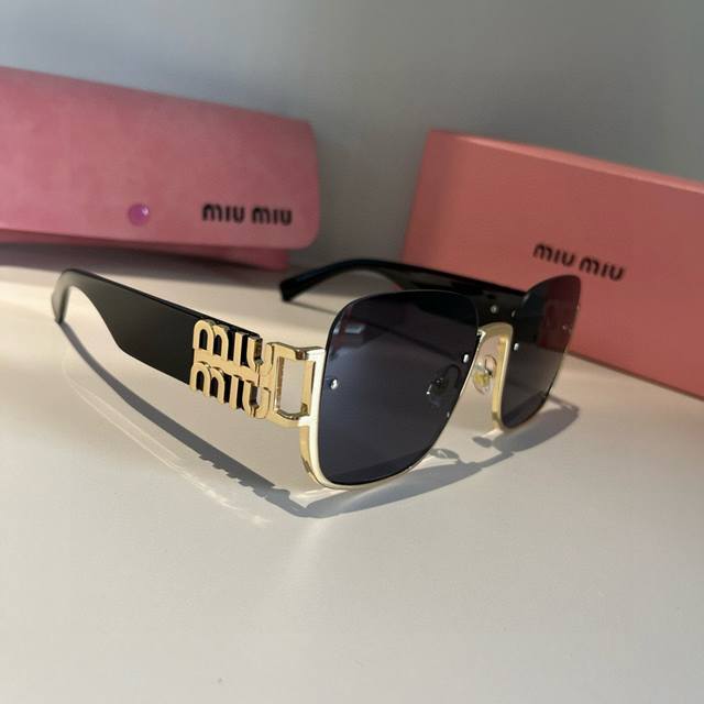 Miu Miu Sunglasses Black with gold logo is always the perfect combination. A mus