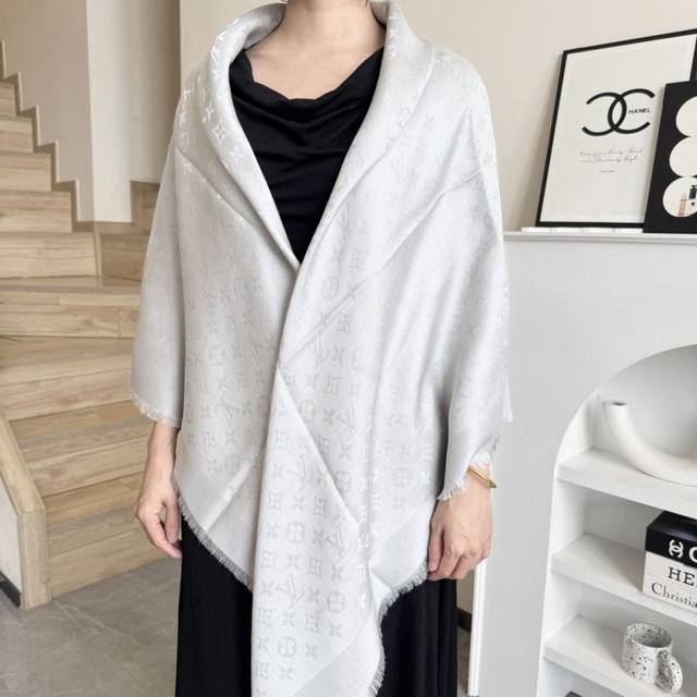 This Louis Vuitton square scarf/shawl features classic gold thread paired with a