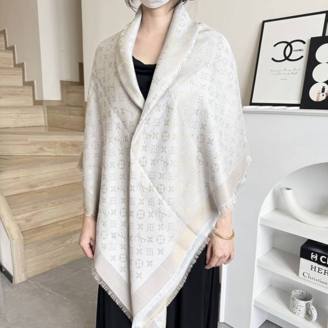 This Louis Vuitton square scarf/shawl features classic gold thread paired with a