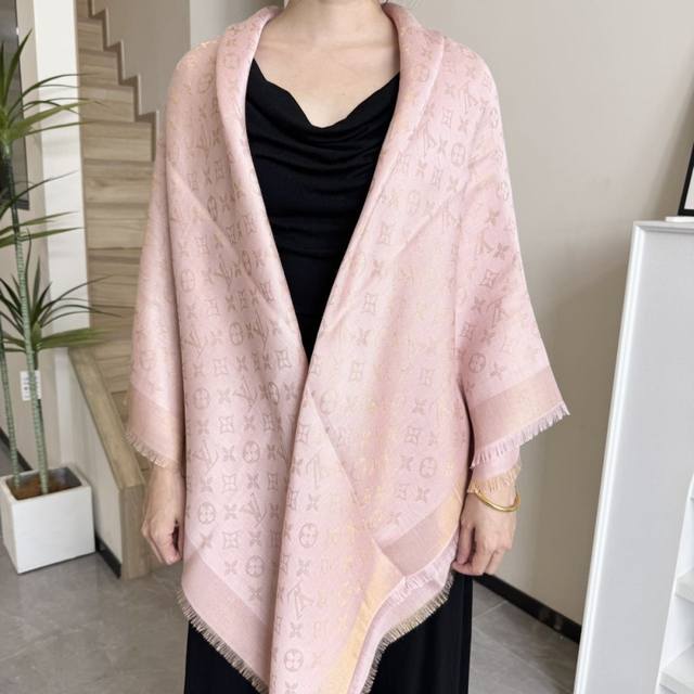 This Louis Vuitton square scarf/shawl features classic gold thread paired with a