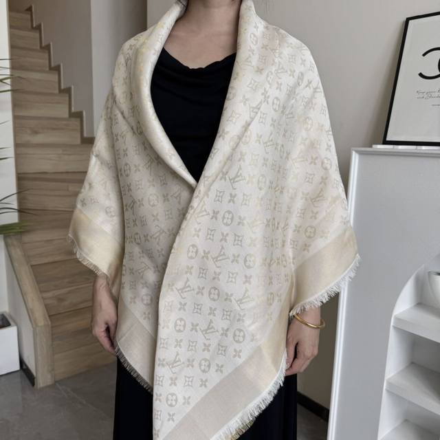 This Louis Vuitton square scarf/shawl features classic gold thread paired with a