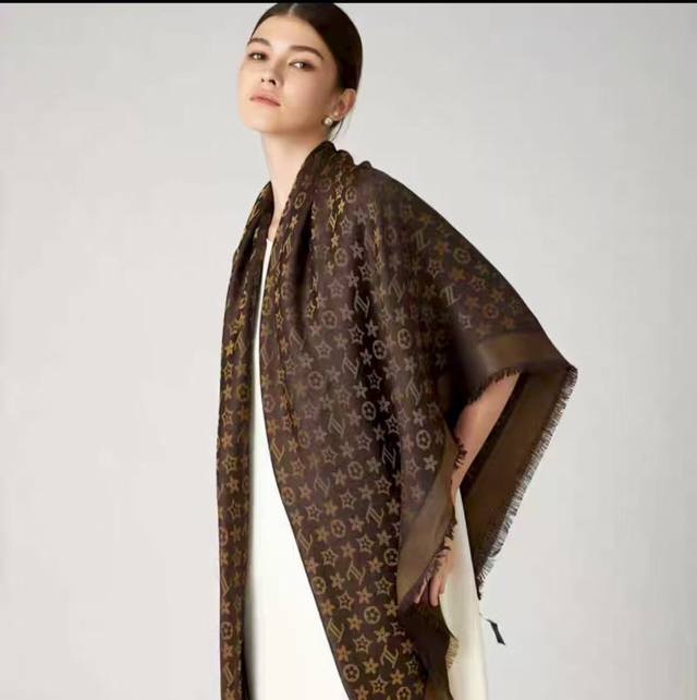 This Louis Vuitton square scarf/shawl features classic gold thread paired with a