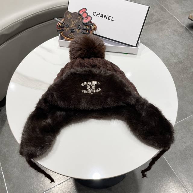 Chanel plush earflap hat with classic double C logo design. The hat body is made