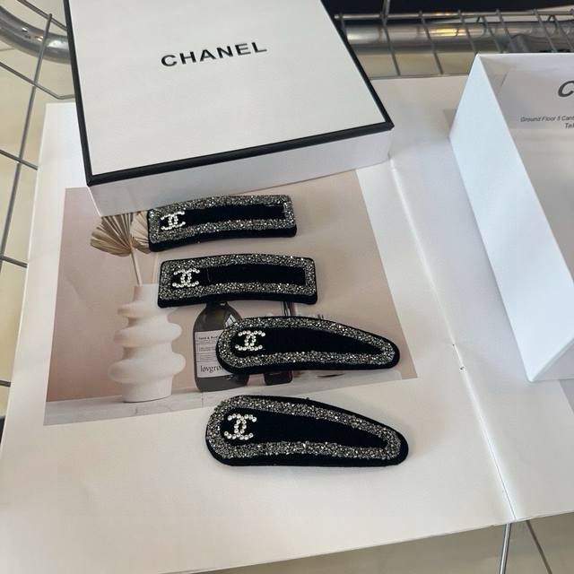 A pair of Chanel hair clips with packaging box. Simple, practical, and stylish!