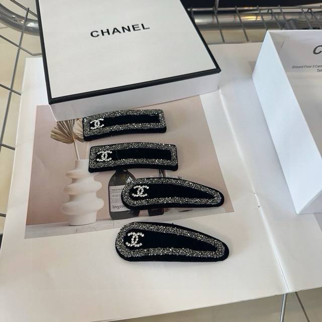 A pair of Chanel hair clips with packaging box. Simple, practical, and stylish!
