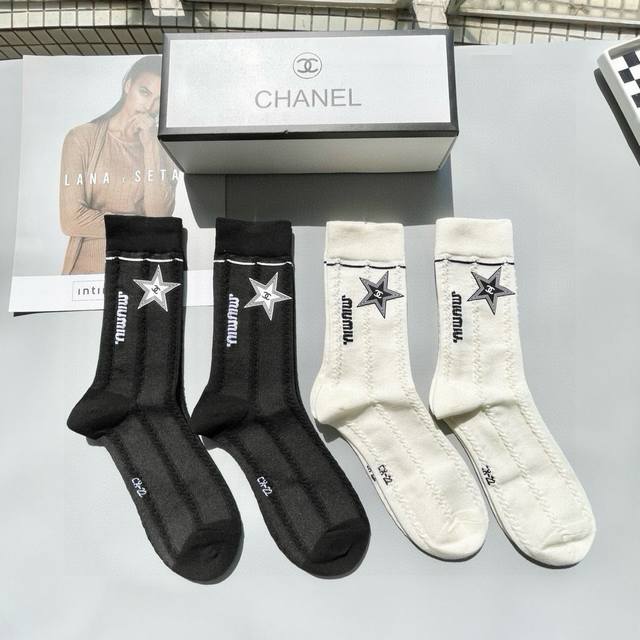 A box of four pairs of Chanel's popular mid-calf socks, high-quality replica, co