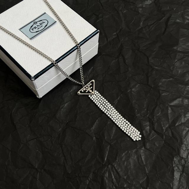 Prada necklace, exquisite and timeless, makes a glamorous debut. The overall de