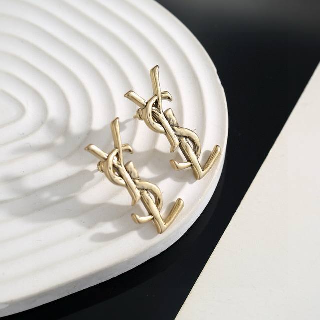 Original brass Yves Saint Laurent earrings. Founded in 1961, Yves Saint Laurent