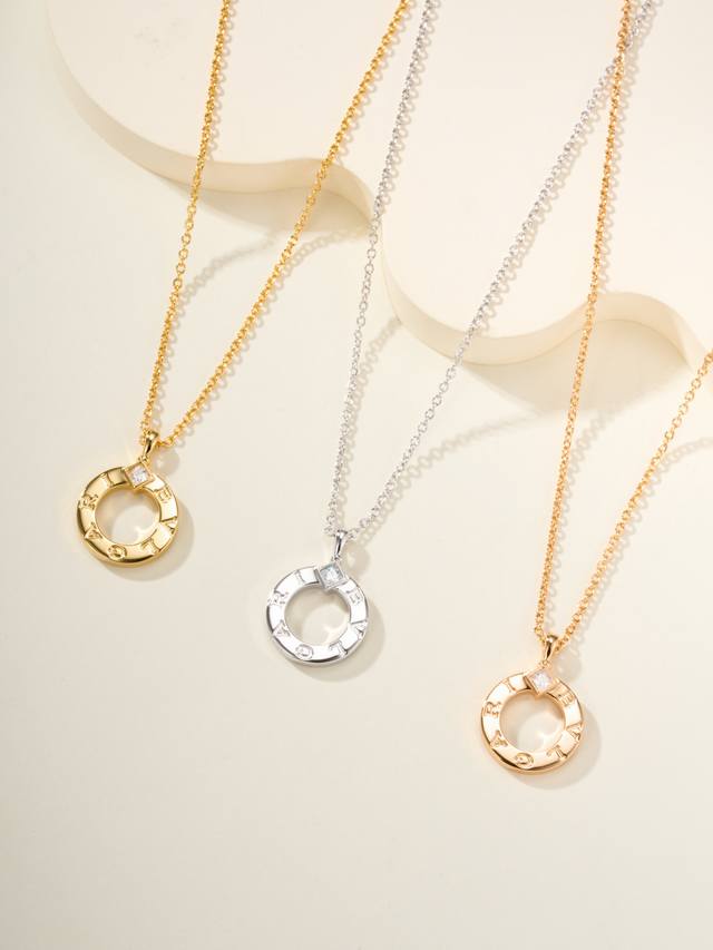 Bv logo-engraved necklace features the logo lettering on a round pendant, remini