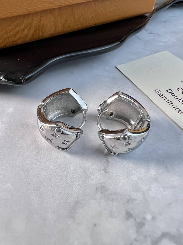 Lv earrings. These Nanogram earrings feature polished metal rings engraved with