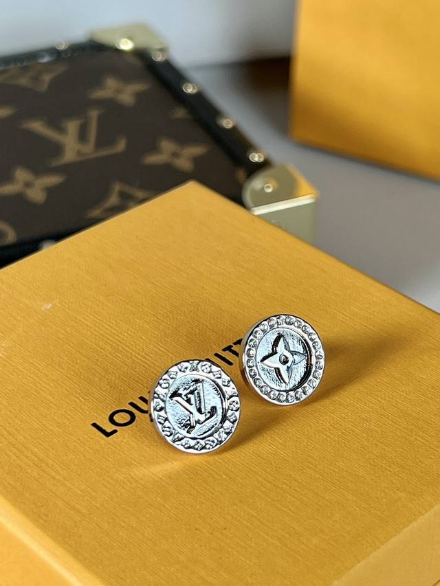 LV earrings feature the classic Monogram flower and LV lettering, surrounded by