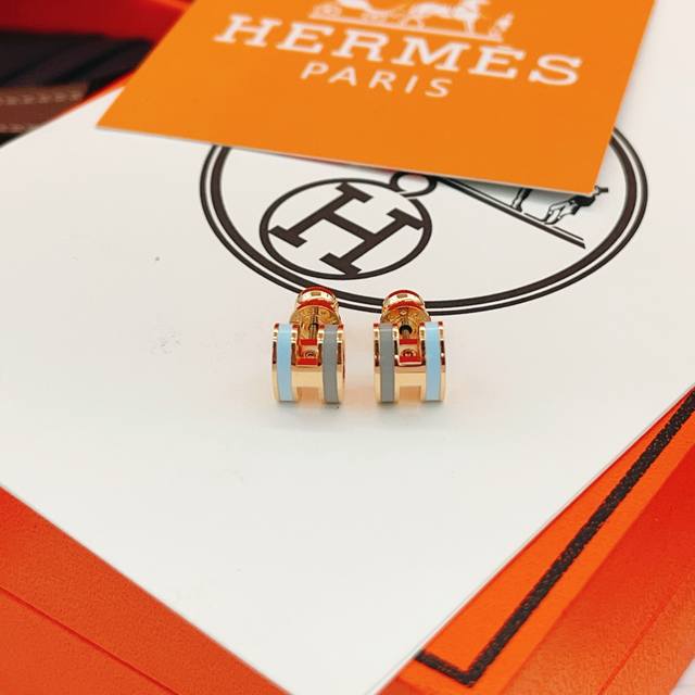 He104 He Mes' latest rose gold, grey, and blue H-style earrings are made of the