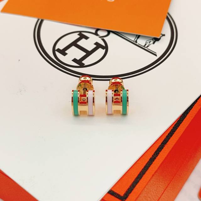 He101 He Mes' latest rose gold, green, and pink H-shaped earrings are made of th