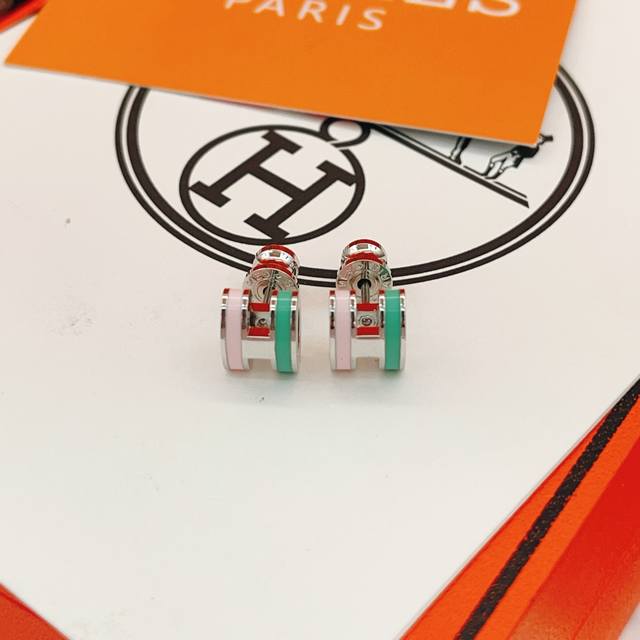 He100 He Mes' latest silver, green, and pink H-shaped earrings are made of the s