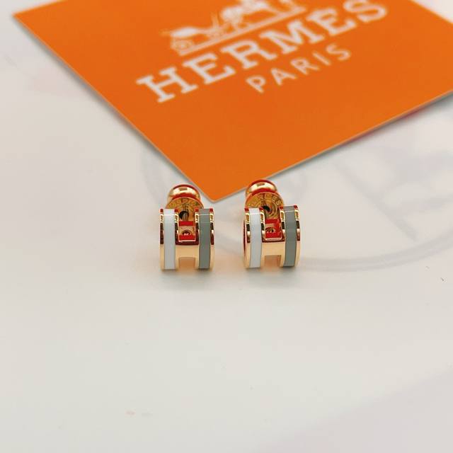 He107 He Mes' latest rose gold, grey, and white H-shaped earrings are made of th