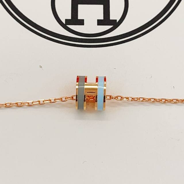 Hx106 He Mes' latest rose gold, grey, and blue mini necklace is made of the same