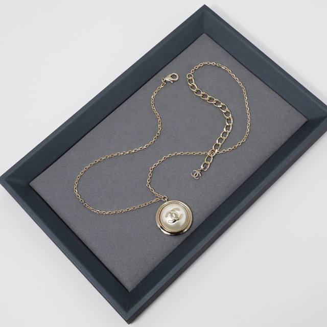 Ch Nel Necklace: A women's necklace with a hemispherical double-C acrylic pendan