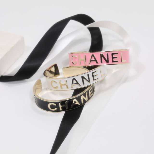 Ch Nel Bangle: A bright gold lettered enamel open bangle. DDD