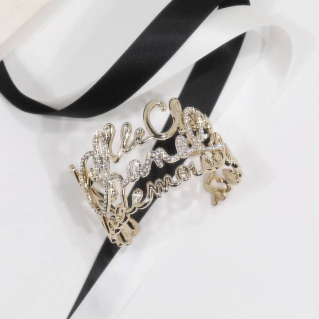 Ch Nel Bangle: A stylish and elegant gold-plated openwork rhinestone bangle feat