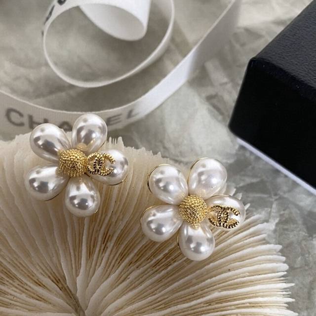 I absolutely love this Chanel design! The camellia and letter pearl earrings ar