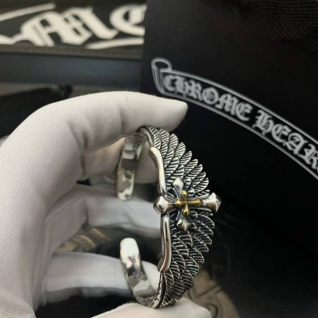 This Chrome Hearts cross-wing open bracelet boasts a unique design with embossed